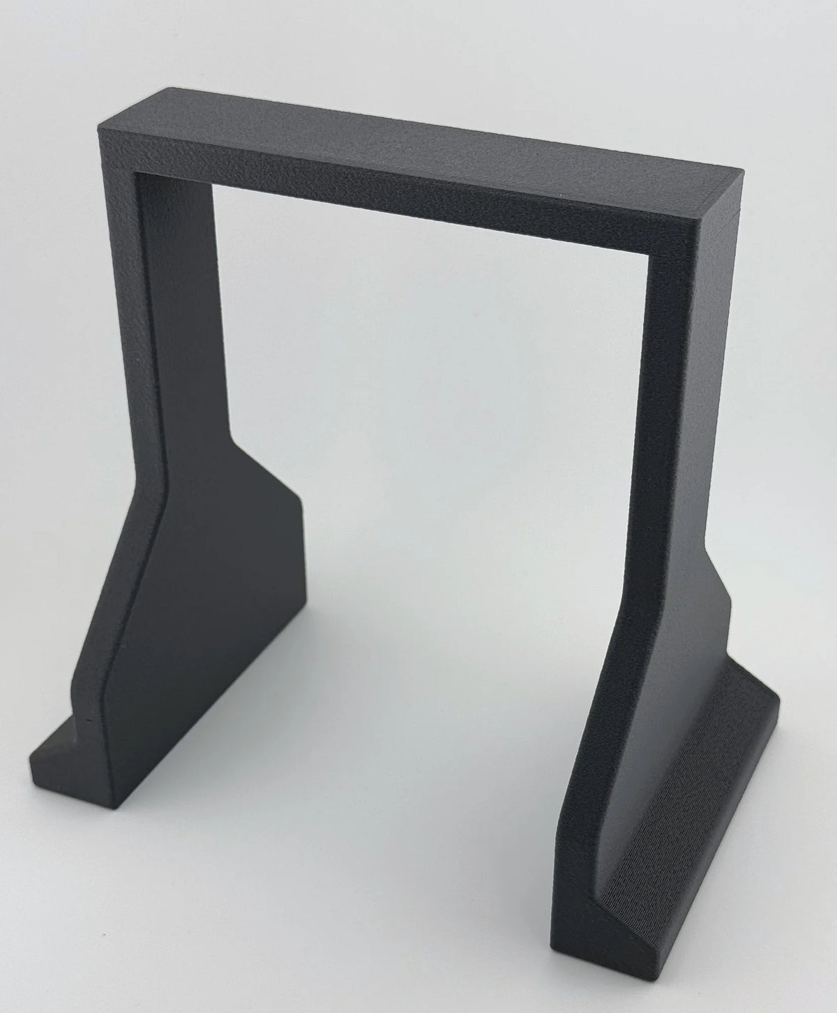 Braille G30 battery hold-down, grey glass-fiber nylon, front view showing the top strap and both feet